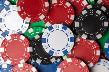 Colorful poker chips on green table. Gambling concept, background