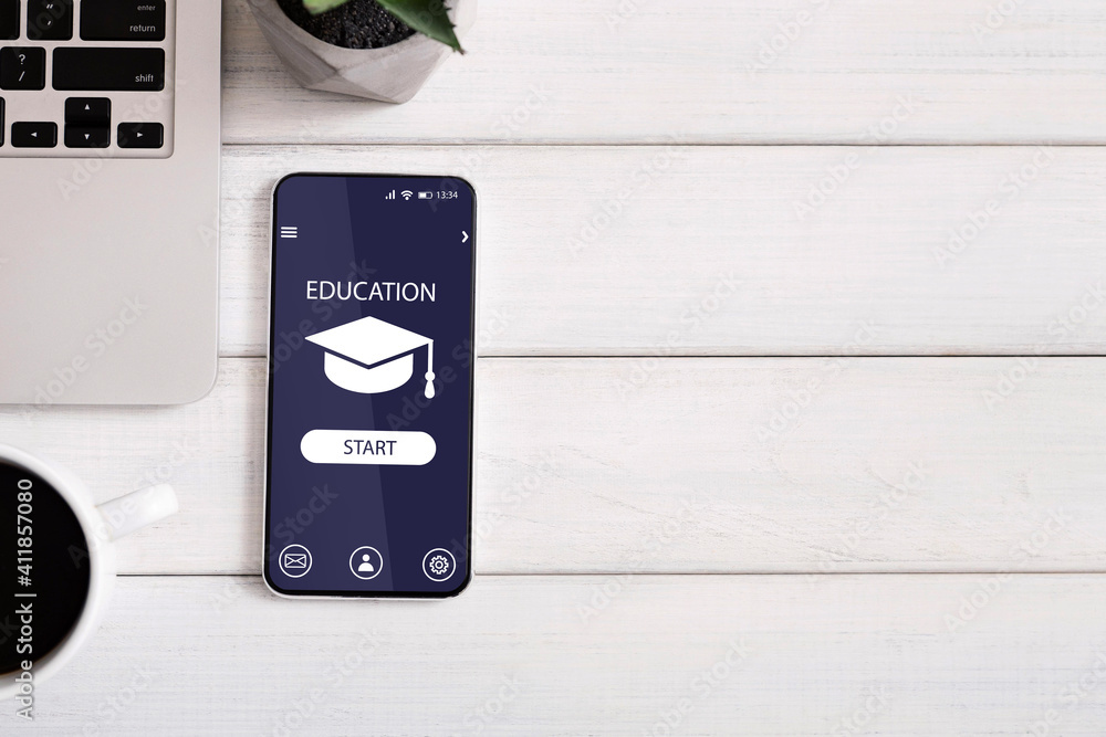 Poster mobile app for online education opened on smartphone flat lay on table