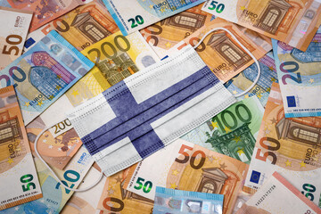 Obraz na płótnie Canvas Medical mask with the flag of Finland on a variety of european banknotes.(series)