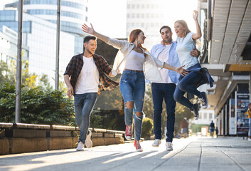 Obraz premium Group of young people hangout at the city street.They walks together and making fun. 