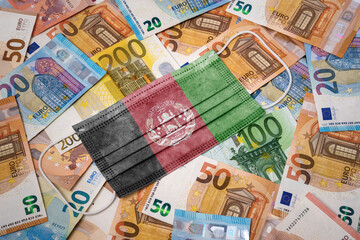 Medical mask with the flag of Afghanistan on a variety of european banknotes.(series)