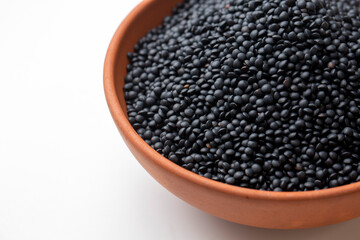 Black beluga lentils on the white background