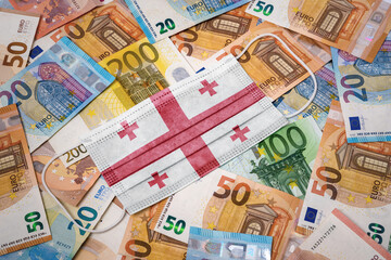 Obraz na płótnie Canvas Medical mask with the flag of Georgia on a variety of european banknotes.(series)