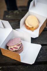 Traditional danish fastelavnsboller with crispy flaky dough and whipped cream on top and powdered sugar. Different types of sweet buns february baked goods for carnival in scandinavia 