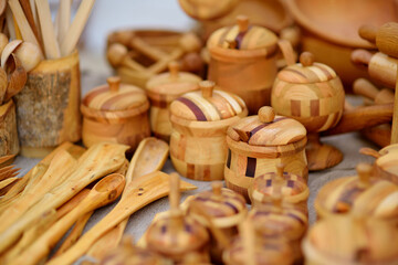 Fototapeta na wymiar Wooden kitchenware sold on Easter market in Vilnius. Lithuanian capital's annual traditional crafts fair is held every March on Old Town streets