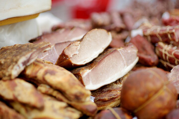 Selection of assorted home made meats, jerky and sausages on a farmer's market in Vilnius,...