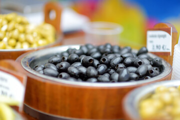 Assorted organic pickled olives, garlic, hot peppers, capers and sundried tomatos sold on a marketplace in Vilnius, Lithuania, during traditional spring fair.