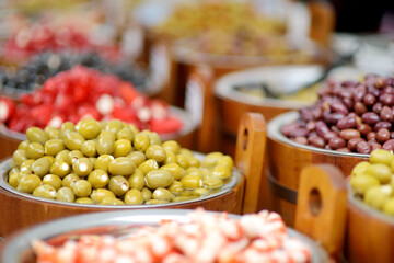Assorted organic pickled olives, garlic, hot peppers, capers and sundried tomatos sold on a marketplace in Vilnius, Lithuania, during traditional spring fair.