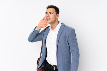 Fototapeta premium Young handsome businessman on isolated background listening to something by putting hand on the ear
