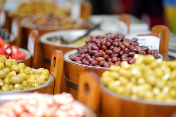 Assorted organic pickled olives, garlic, hot peppers, capers and sundried tomatos sold on a marketplace in Vilnius, Lithuania, during traditional spring fair.