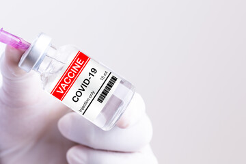 Close-up doctor, nurse or scientist hands in gloves holding syringe and liquid vaccine prevention immunization and treatment from coronavirus flu, infection medical concept of vaccination.