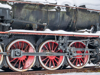 Fototapeta na wymiar Close up with train wheels on track. Wheels of a train on the railway tracks.