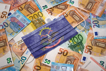 Medical mask with the flag of North Dakota on a variety of european banknotes.(series)