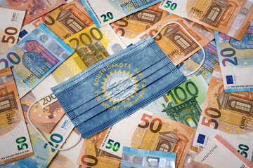 Medical mask with the flag of South Dakota on a variety of european banknotes.(series)