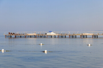 Fototapeta na wymiar Wooden pier in the Black sea in Skadovsk, Ukraine