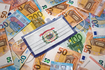 Obraz na płótnie Canvas Medical mask with the flag of West Virginia on a variety of european banknotes.(series)