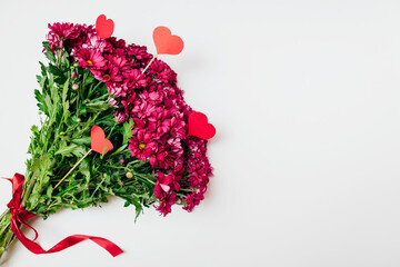 Valentine's day background. Bouquet of red chrysanthemum and hearts. Present gift for holiday. Space