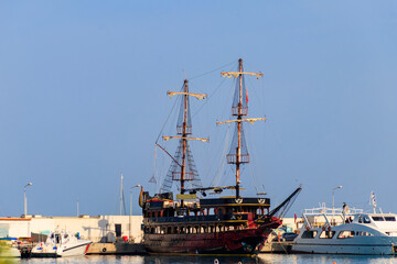Fototapeta na wymiar Stylized pirate yacht in marina harbor in Kemer, Turkey