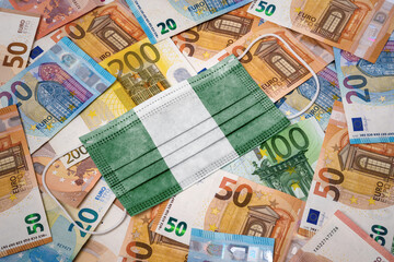 Obraz na płótnie Canvas Medical mask with the flag of Nigeria on a variety of european banknotes.(series)