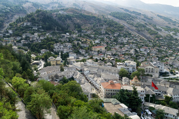 Fototapeta na wymiar Gjirokaster, Albania, Europe, well-preserved Ottoman town. View from the citadel upon the stone roofs of the city, UNESCO World Heritage.