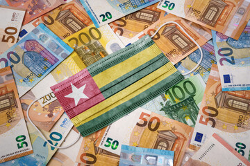 Medical mask with the flag of Togo on a variety of european banknotes.(series)