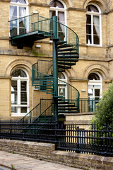 Fototapeta na wymiar An iron spiral stairway at the rear of the historic Victoria Hall in Shipley provides an elegant first floor fire escape