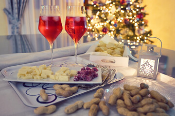 aperitif for two people with Christmas tree in the background