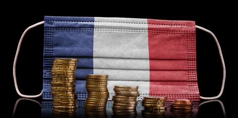 Medical mask with the flag of French Guiana behind some shrinking stacks of various coins.(series)