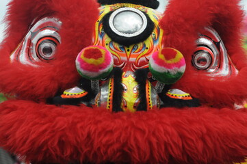 
Malang, Indonesia - February 10, 2020: Dance of colorful lions and dragons at the Chinese New Year parade.