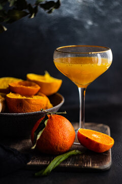 Freshly squeezed orange juice and halved oranges