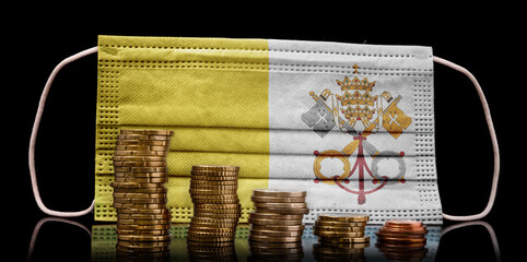 Medical mask with the flag of Vatican City behind some shrinking stacks of various coins.(series)