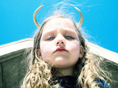 Portrait of a girl with devil horns