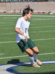 Young Athletic boy kicking the ball during a soccer game