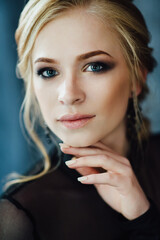Blonde girl with blue eyes in a black dress © omelnickiy