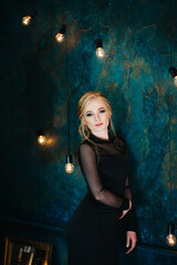 Blonde girl with blue eyes in a black dress © omelnickiy