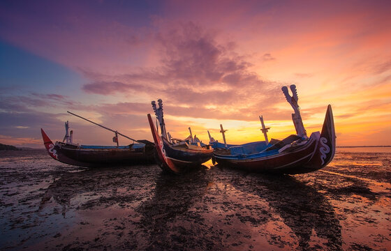 Three traditional boats on beach at sunset, Tuban, Bali, Indonesia
