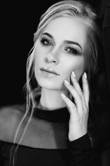 Blonde girl with blue eyes in a black dress © omelnickiy