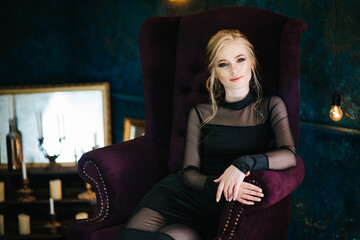 Blonde girl with blue eyes in a black dress © omelnickiy