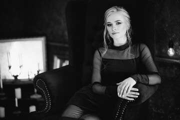 Blonde girl with blue eyes in a black dress © omelnickiy
