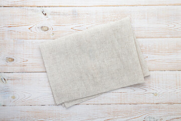 Empty canvas napkin on wooden desk top view, mockup