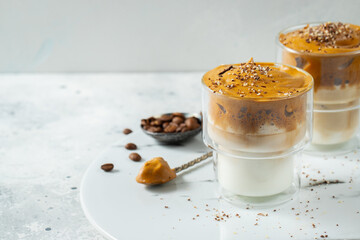 Dalgona coffee. Iced fluffy creamy whipped trend drink with coffee foam and milk. Trendy drink during Covid-19 city lock down and self quarantine, stay at home concept