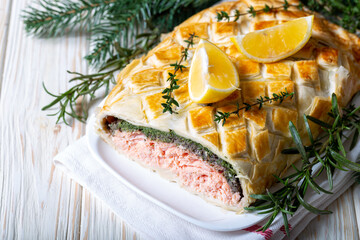 Homemade Salmon Wellington. It is made from Salmon Fish, spinach, mushrooms, spices, herbs and puff pastry. Copy space.