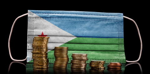 Medical mask with the flag of Djibouti behind some shrinking stacks of various coins.(series)