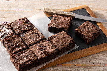Homemade pieces of brownies on wooden table