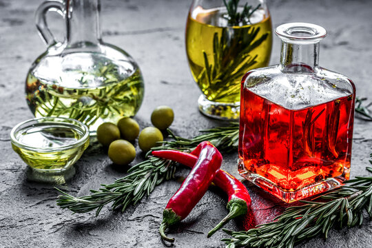 natural oils concept with fresh olives and chili paper on table background
