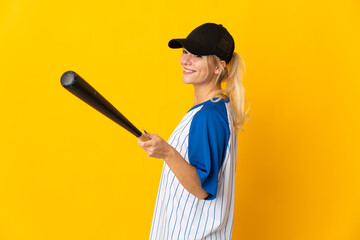 Young Russian woman isolated on yellow background playing baseball