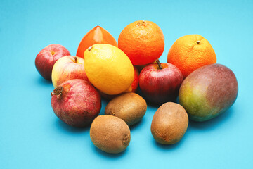 Many fresh fruits isolated on blue background.
