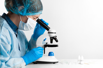 Scientist woman with a microscope, pharmaceutical research and tests.