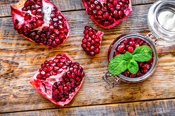 sliced pomegranate on wooden background top view