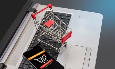 Secure checkout concept with shopping cart on laptop keys
